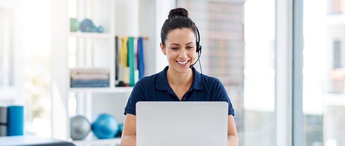 An occupational therapist dictating a long assessment report by headset in a clinic office